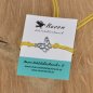Preview: Armband aus gewachster Baumwolle in gelb mit Charm "Schmetterling" aus Edelstahl 304 und Schiebeverschluss mit Perle aus Edelstahl 304